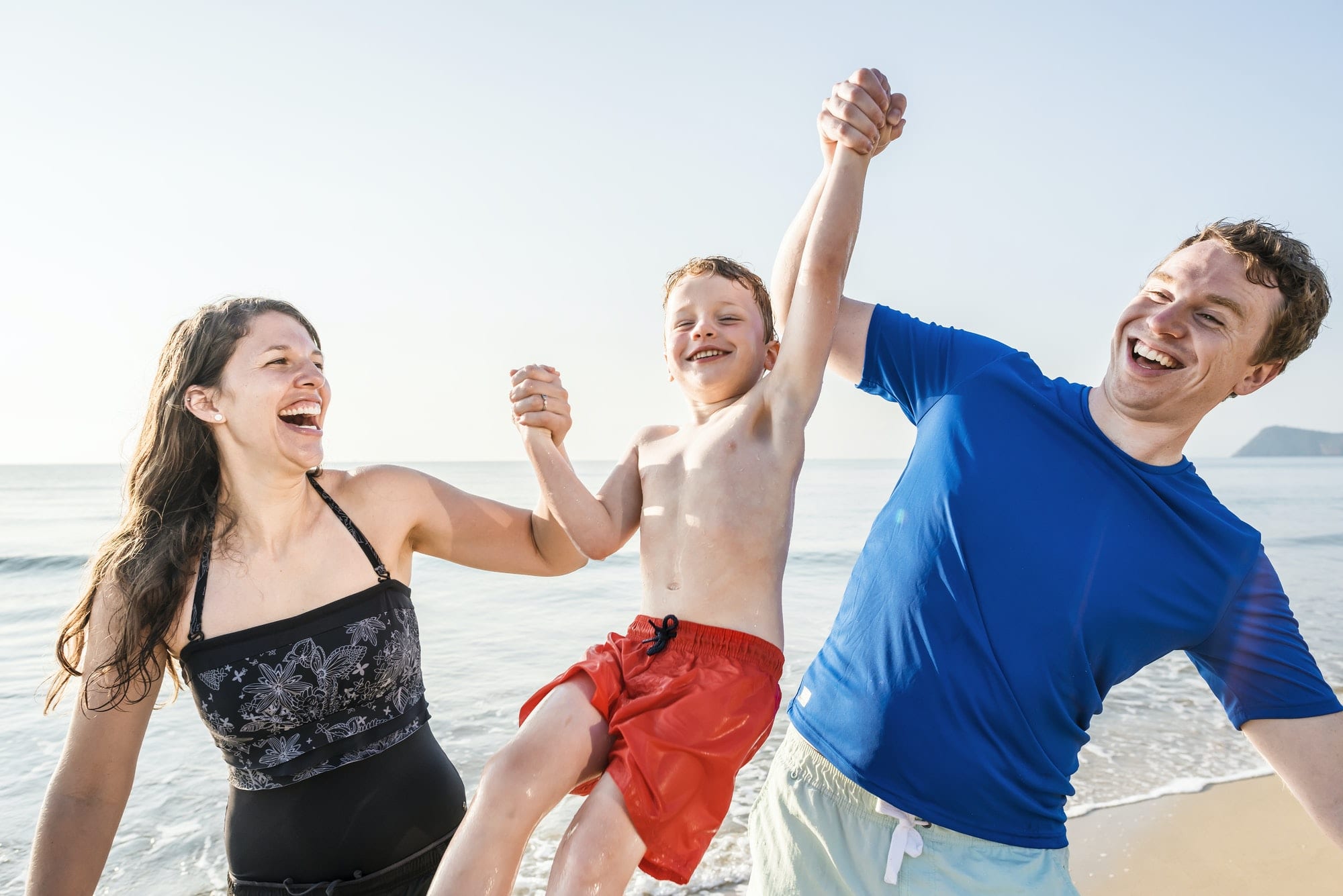 Family playing on the beach