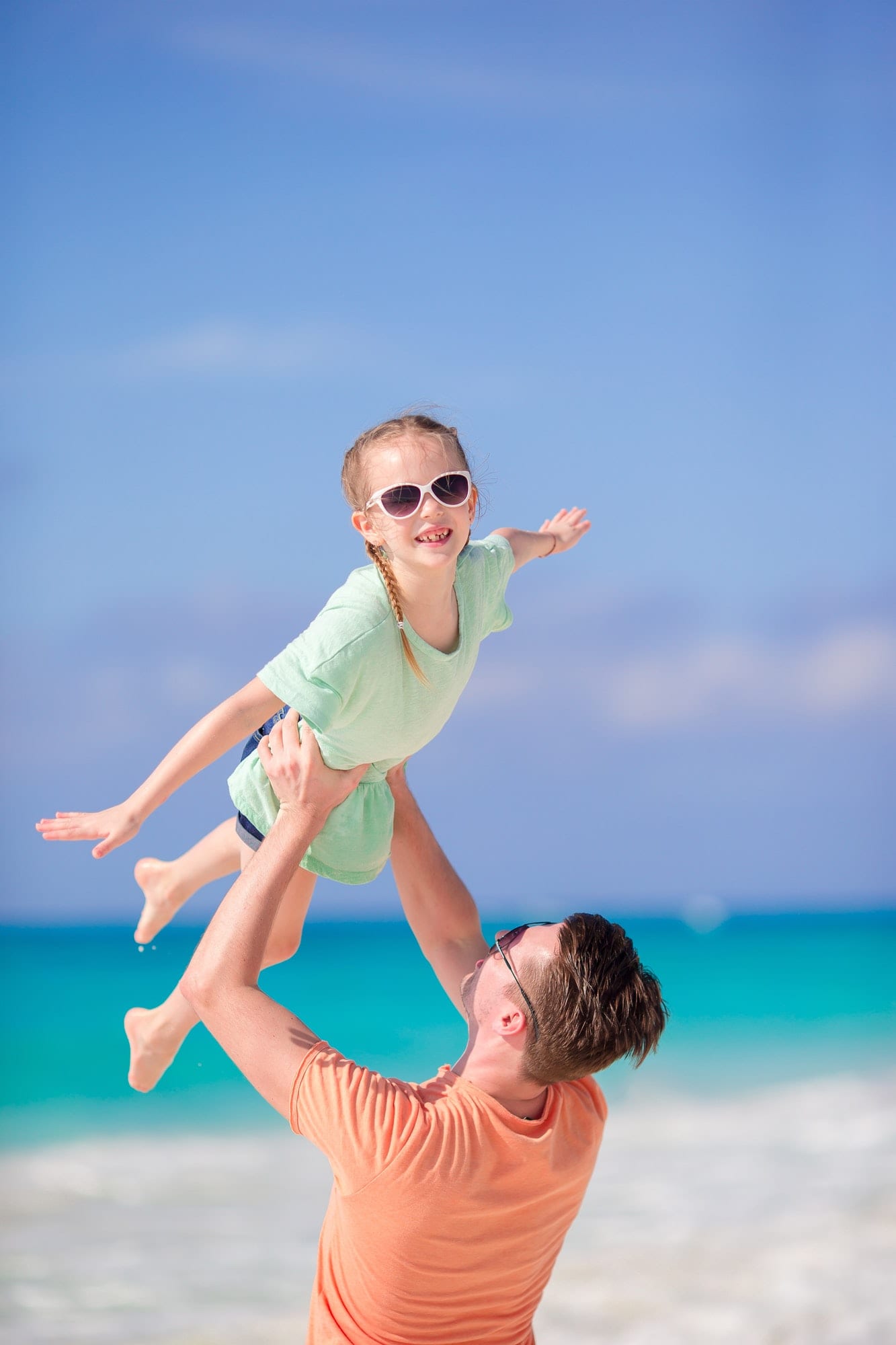 Family beach holiday. Little girl and happy dad having fun during beach vacation